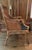 Offering this British Colonial styled Arm chair with curved rattan frame, woven paneled back and side panels, upholstered...
