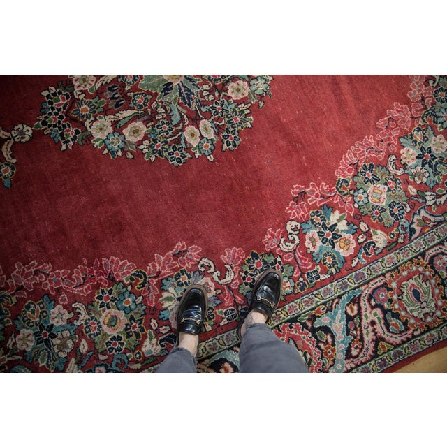 Center medallion in sharp serrated leaves largely defined by floral bouquet design density atop an open field with...