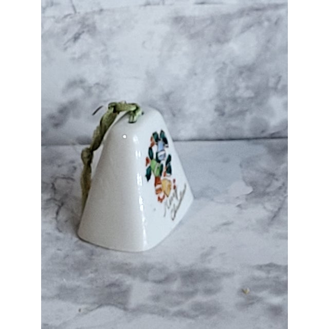 Fabulous vintage mid century Christmas ornament in cow bell shape and "Merry Christmas" in script lettering. Mid-century...