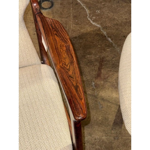 Nice pair of mid-century modern rosewood Danish armchairs from the 1960s. These vintage chairs perfectly capture the retro...