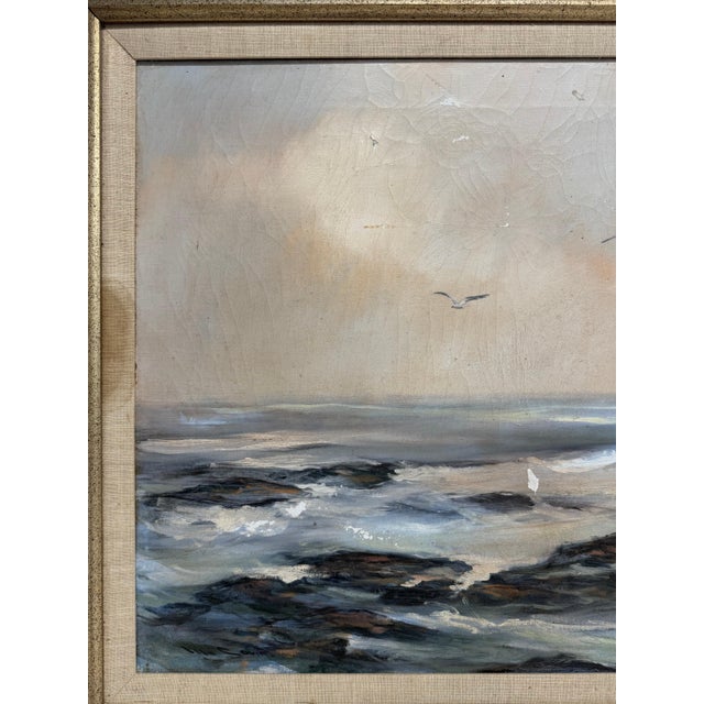 This vintage oil on canvas painting depicts a seascape with crashing ocean waves and flying seagulls by Texas artist...