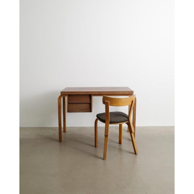 An early and unique set of a finnish mid century modern desk by alvar aalto with laminated birch wood frame and two...