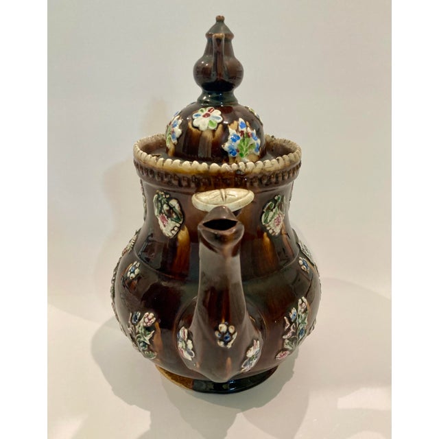 A lovely and large antique English 19th Century Measham Pottery Bargeware teapot decorated with applied colorful flowers...