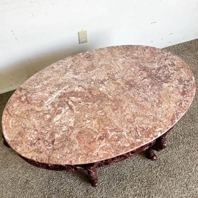 Elevate your living space with this exquisite Chinese Rosewood Hand Carved Pink Marble Top Oval Coffee Table. This...