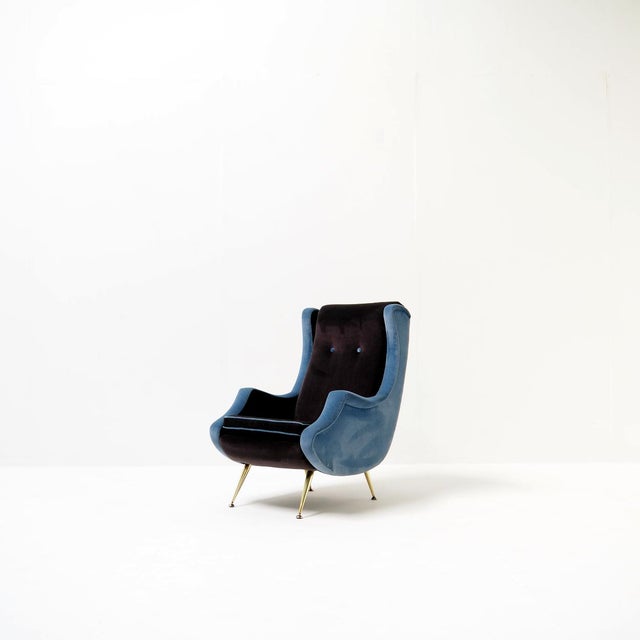 This elegant high-back lounge chair is a striking example of mid-century design, combining iconic style with a fresh,...