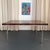 This burl walnut and chrome extension dining table was made in Switzerland and retailed by the prestigious American...