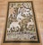 This vintage American hand-hooked tapestry presents a charming and imaginative forest scene of genuine narrative richness...