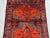 This beautiful vintage Afghan hand-knotted rug showcases a traditional tribal geometric design featuring a striking red...