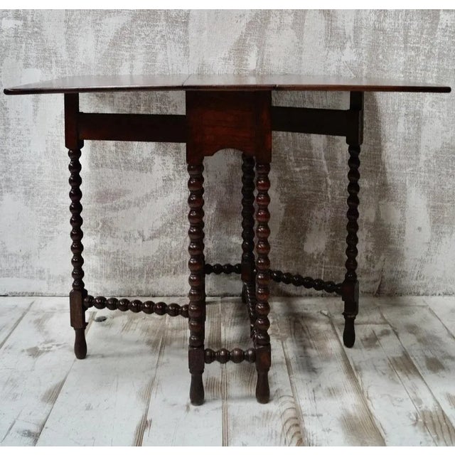 A superb small antique oak gate leg table. Made from Oak, with two drop leaves that rest on two swing out gate legs...