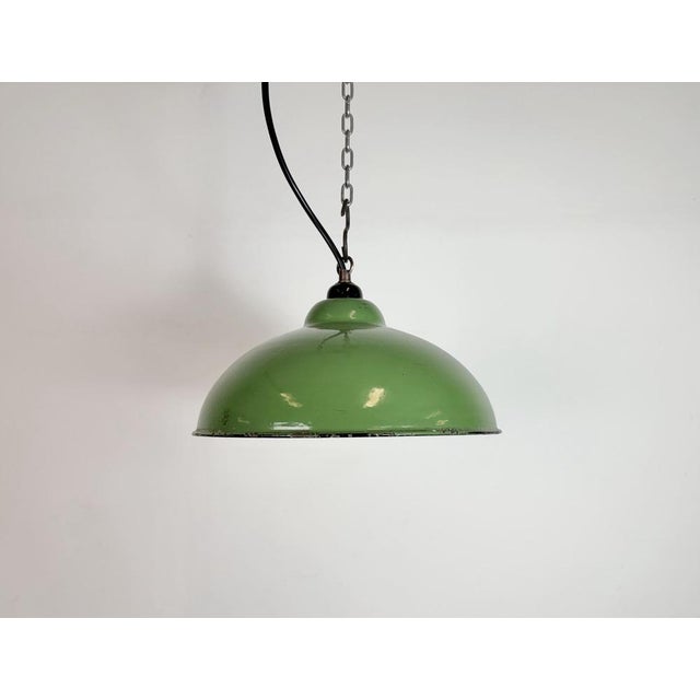 Industrial green enamel factory pendant light made in the former Czechoslovakia during the 1960s. White enamel inside the...