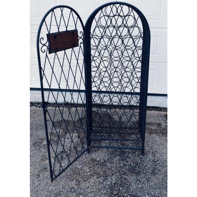 Old style bottle rack with opening capacity for 59 bottles. Metal. Dimensions: height 142, width 56, depth 36. In its...