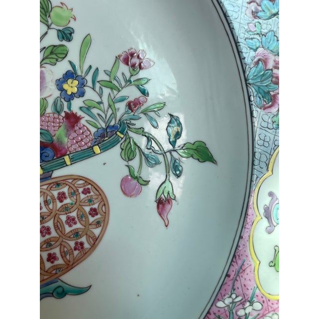 A large 16” diam Chinese 18th century famille rose export porcelain charger, decorated with flowers in a basket.