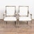 Pair of 19th century Swedish Gustavian armchairs crafted in pine. The chairs feature carved fluted detailing throughout,...