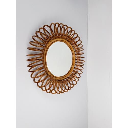 Rare Italian Mid-Century Modern sunburst mirror, entirely handcrafted in cane, rattan, and bamboo, skillfully bent and...