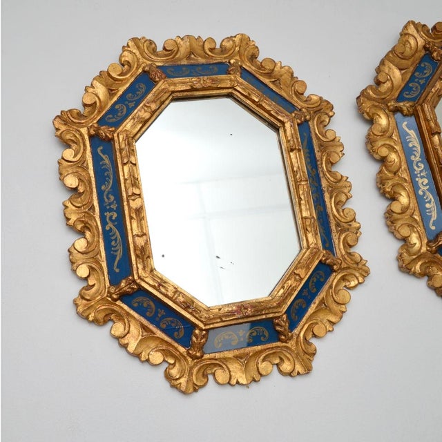 A stunning pair of antique Italian decorative gilt wood mirrors. They are in the classical Rococo style, they were made in...