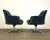 A pair of mid century modern chrome star swivel base lounge chairs designed by Nico Zographos. Upholstered in a blue green...