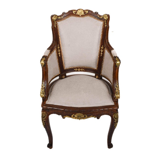 This Antique French Louis XVI Parlor Chair blends stately elegance with refined craftsmanship. The walnut frame is richly...