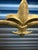 This antique metal fireplace screen features a gently arched frame, riveted detailing, and a decorative fleur‑de‑lis crest...