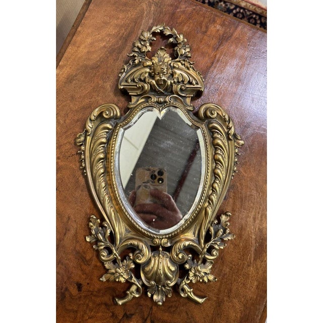 Louis XV Rococo style gilt bronze putto mirror Decorated with period attributes Lovely violin shape