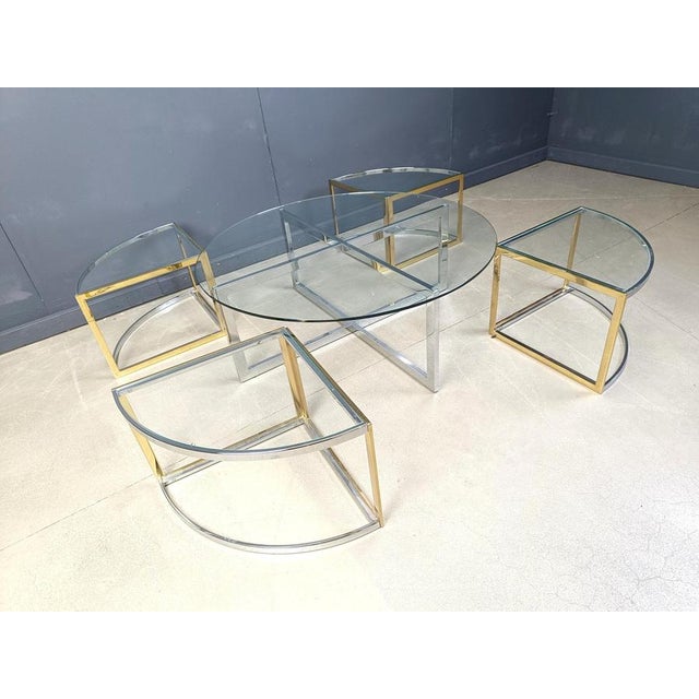 Large coffee table set by Maison Charles consisting of 4 nesting tables in brass and chrome with clear glass tops and a...