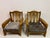 A pair of solid oak armchairs in a restrained Brutalist style, dating to the mid-20th century. The design combines robust...