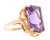 10K Yellow Gold and Amethyst Cocktail Ring. Prong set rectangular faceted Amethyst stone, approximately 17mm x 5mm. Ring...