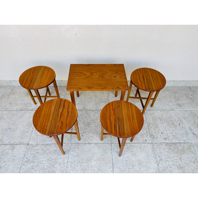 A stunning set of scandinavian-inspired nesting tables, comprising a rectangular main table and four round side tables...