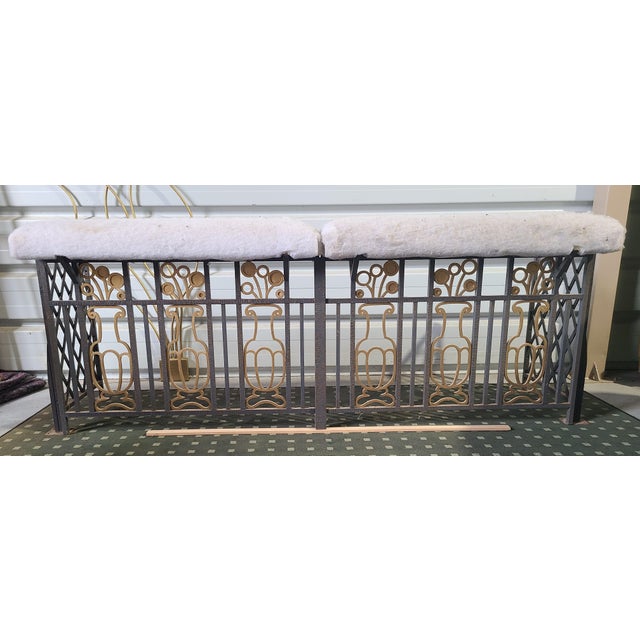 Fender Art Deco club chair in solid hammered wrought iron, decorated with a stylized floral Medici vase and gilt details....