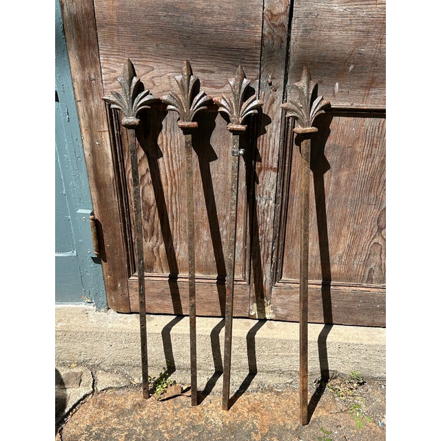 Set of 4 antique fence posts with substantial fleur-de-lis type finials used as plant supports or garden / interior decor....