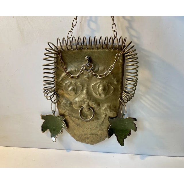 A one of a kind chain-suspended warrior wall head in brass. It made entirely from re-purposed/recycled parts. It features...