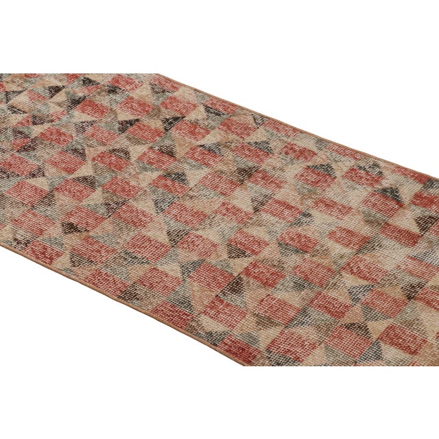 Hand-knotted in wool and originating from Turkey circa 1960 – 1970, this 2x7 vintage Zeki Müren runner is a unique...