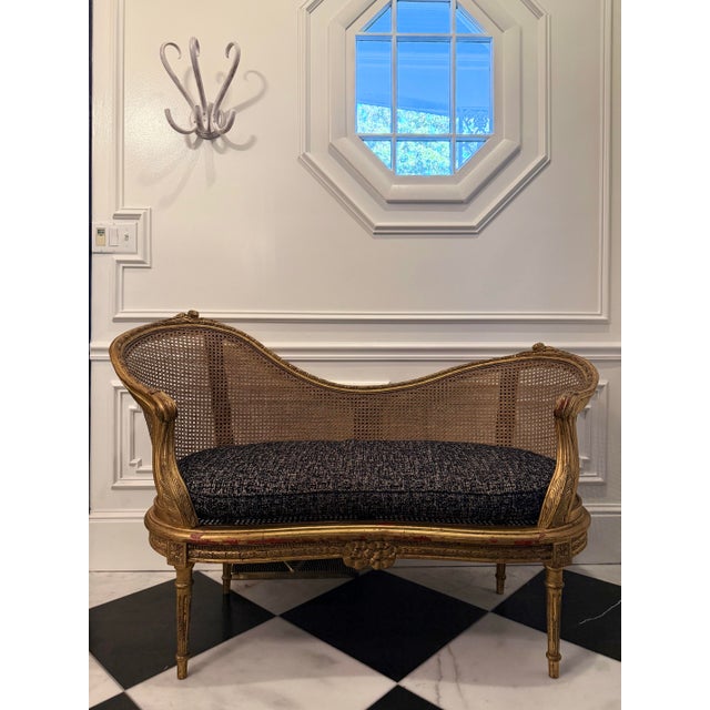 A stunning Antique Italian Giltwood Cane Settee, beautifully carved and finished in original gold leaf with traces of red...