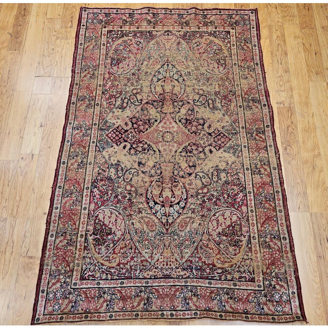 "An exquisite 19th century Persian Kerman Lavar rug, handwoven in the late 1800s, showcasing the artistry of one of...