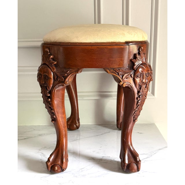 This spectacular "Thornton White Charleston", heavily stylized Chippendale-style oval footstool showcases highly...
