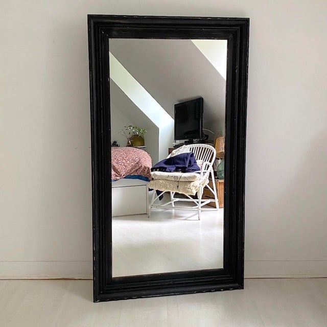 1950s mirror Matte black patinated wood Signs of wear, chips, and minor losses. Can be hung horizontally or vertically....