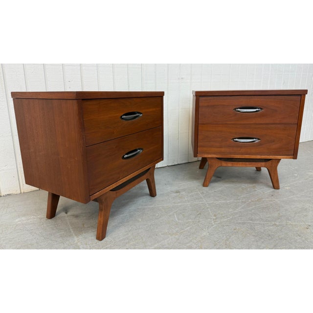 This listing is for a pair of Mid-Century Modern Walnut Nightstands. Featuring a straight line design, two drawers for...
