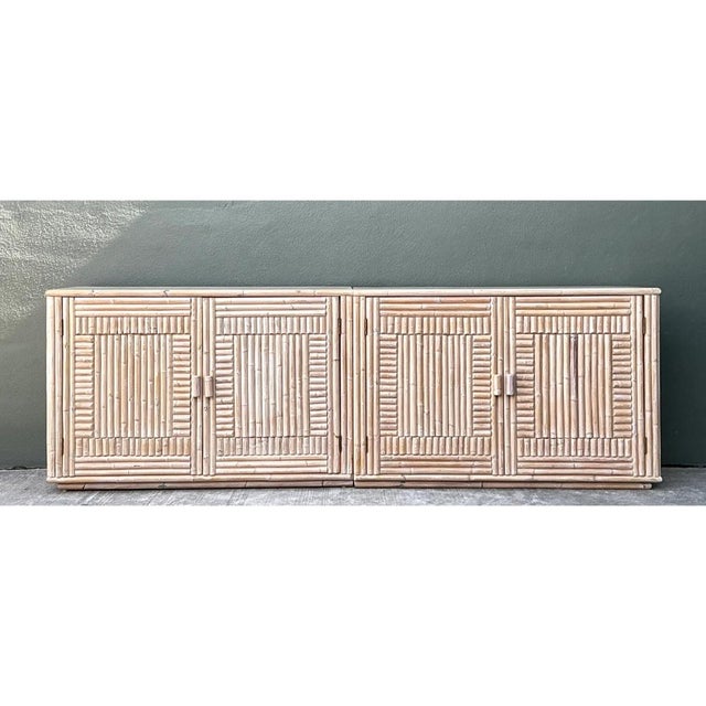 This vintage credenza is a monumental piece of rattan craftsmanship, with a long, low, architectural profile and a soft,...