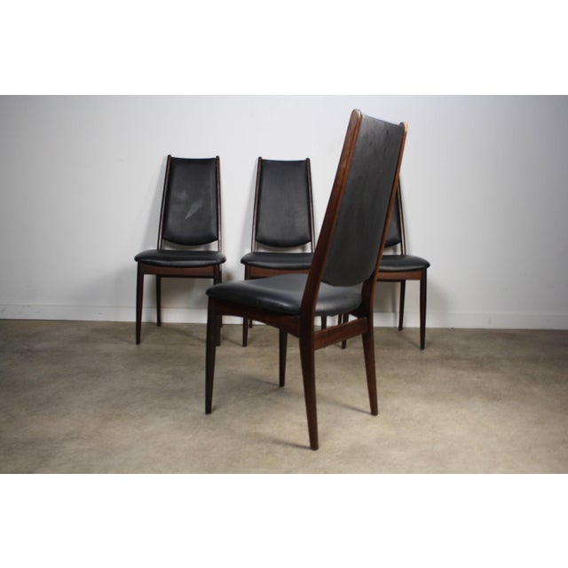 About the Rosewood Danish Modern Dining Chairs - A Set of 4 This set of 4 Danish Modern Dining Chairs in brilliant...