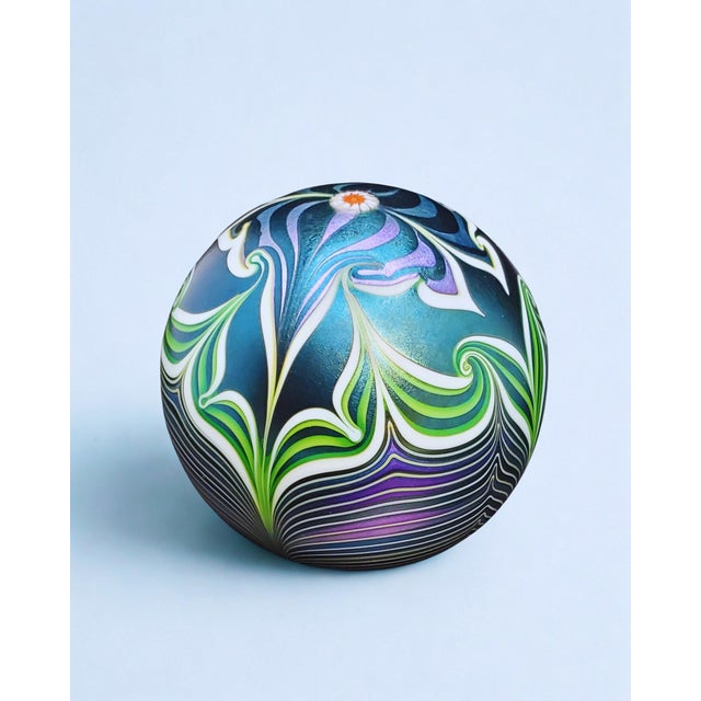 This Signed Orient & Flume Flower Art Glass Paperweight from 1979 features beautiful iridescent blue and purple colors....