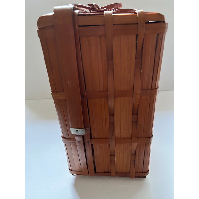 This is a pristine “suitcase” style picnic basket. It is rich a beautiful reddish-brown color. It could be used for a...