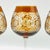 A unique set of amber cut-to-clear wine glasses, crafted in the rich Bohemian glassmaking tradition. These elegant stemmed...