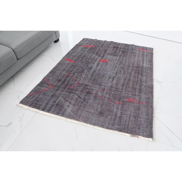 This is a vintage Turkish Oushak rug from the Mid 20th Century. The piece was hand-knotted.