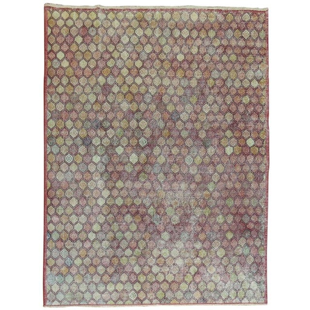 A Mid-Century room size Turkish deco rug with an all -over diamond shaped motif on a raspberry background. Measures: 8'2''...