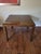 Large square Parsons-style side table in the manner of Milo Baughman, finished in a striking mottled copper-brown burl-...