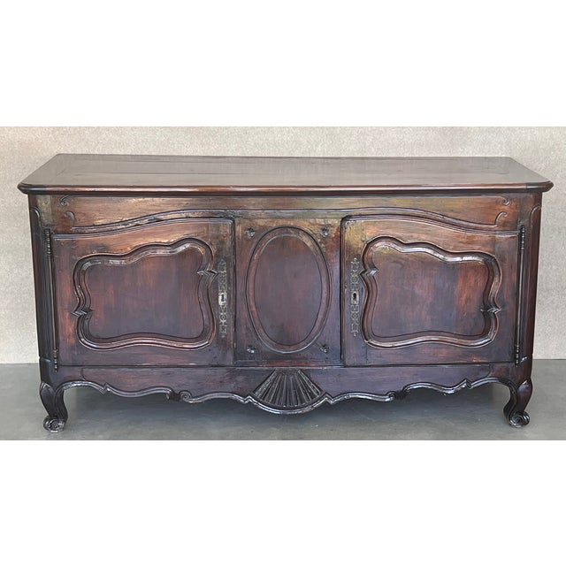 About Grand antique French walnut Louis XIV buffet ~ Sideboard is a masterpiece of the cabinetmaker's art. Rendered from...