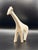 A striking minimalist giraffe sculpture defined by its elongated neck, clean lines, and soft matte white finish. This...