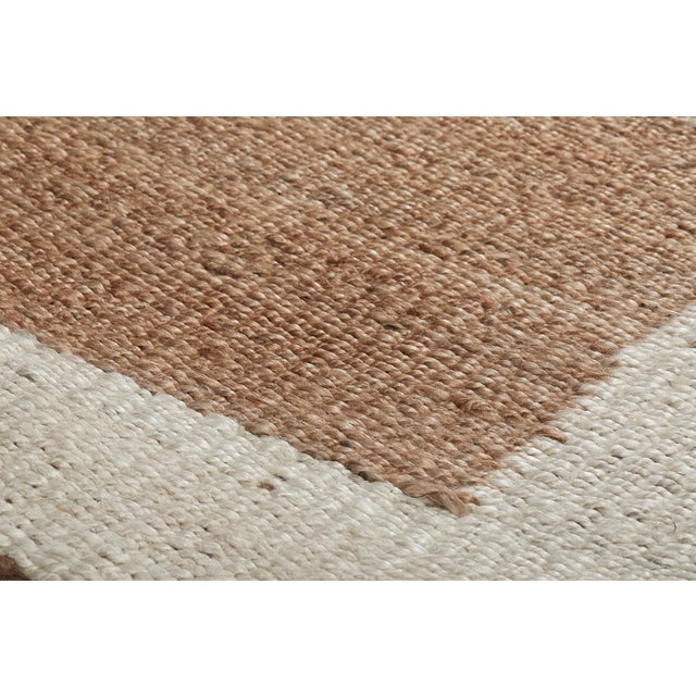 Natural jute hand woven rug with ivory toned border. Classic yet modern; perfect for a wide variety of interior spaces....