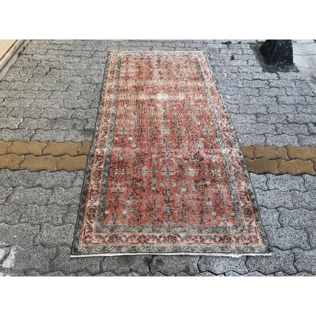 This is a vintage Turkish Oushak rug from the 1960s. The piece was hand-knotted.