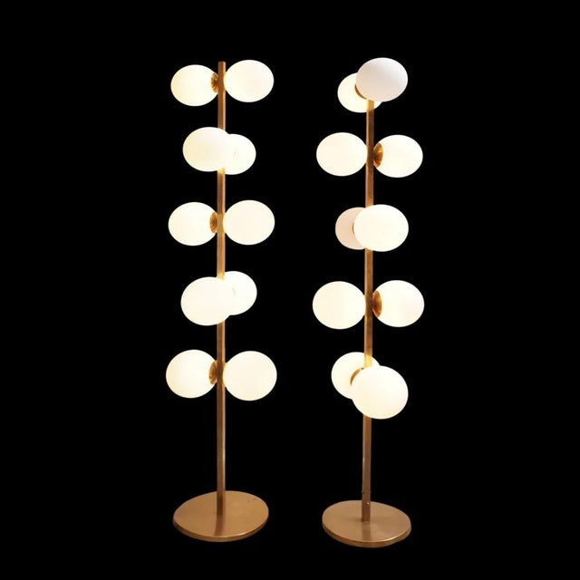 These vintage Italian brass floor lamps capture the essence of mid-century glamour with a sculptural, vertical presence....