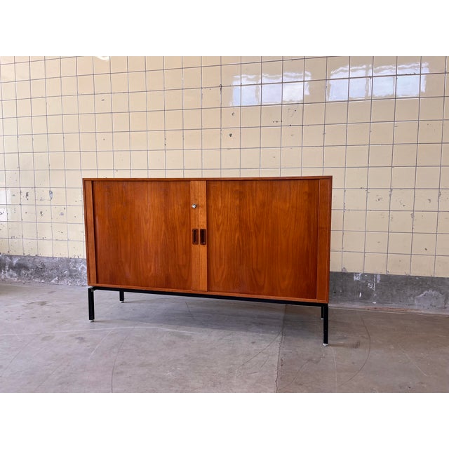 This elegant sideboard, designed by Scanform and made in Denmark, is crafted in warm teak and showcases the refined...